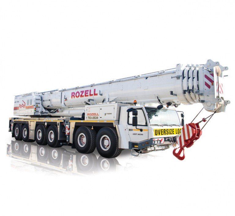 White Rozell crane truck with an extended boom, labeled