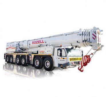 White Rozell crane truck with an extended boom, labeled