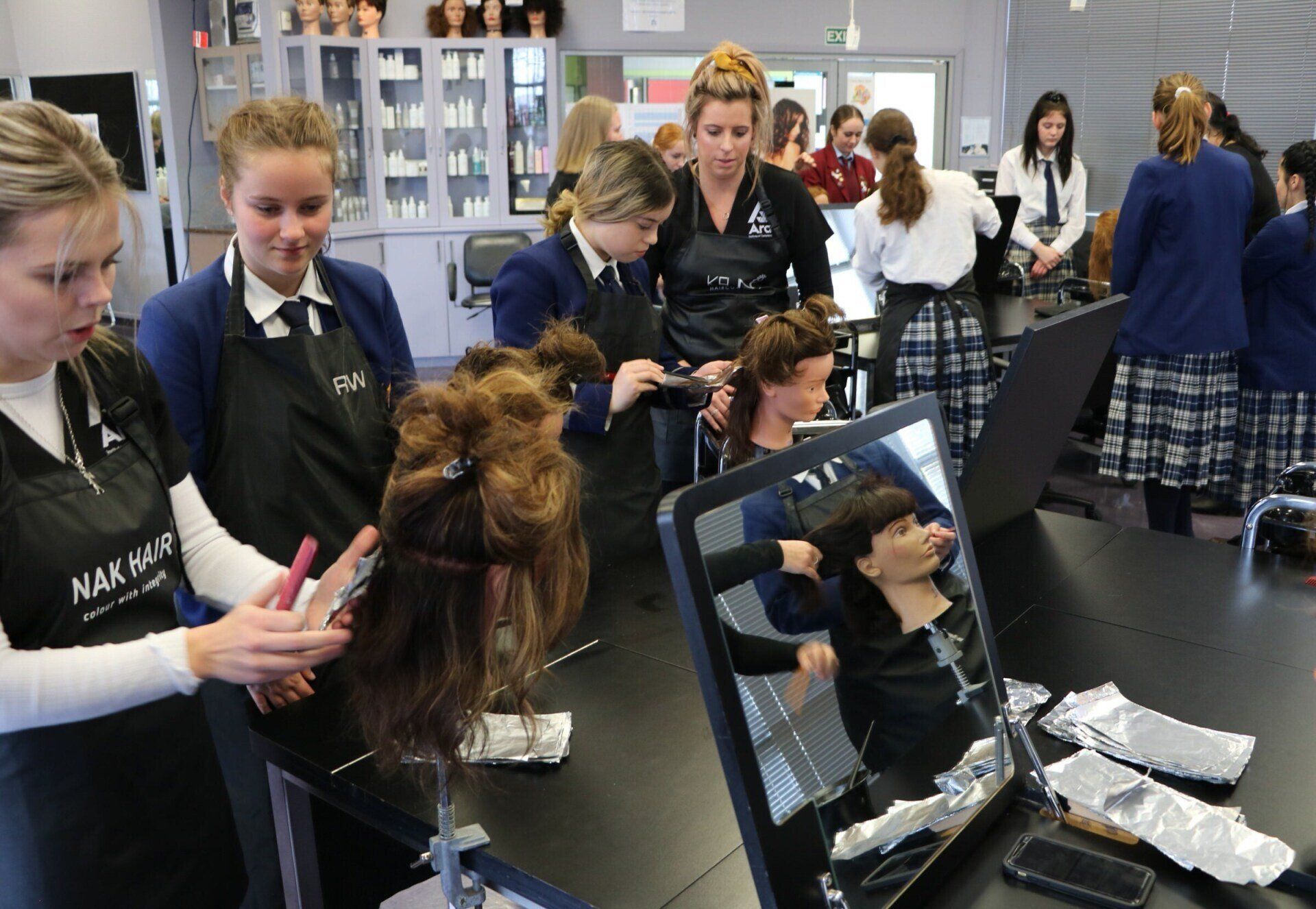 Timaru Girls Hig School | A group of women are working on mannequins in a salon.