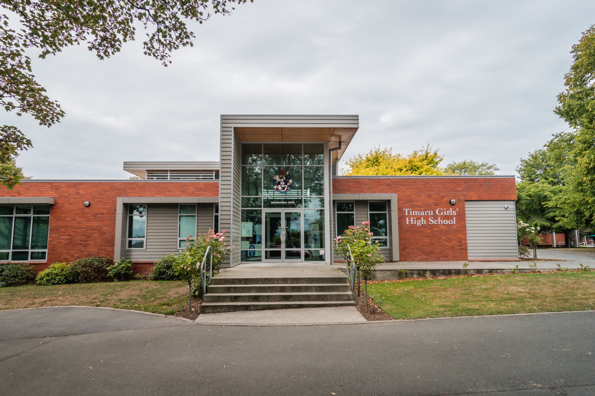 A large brick building with stairs leading up to the entrance.
