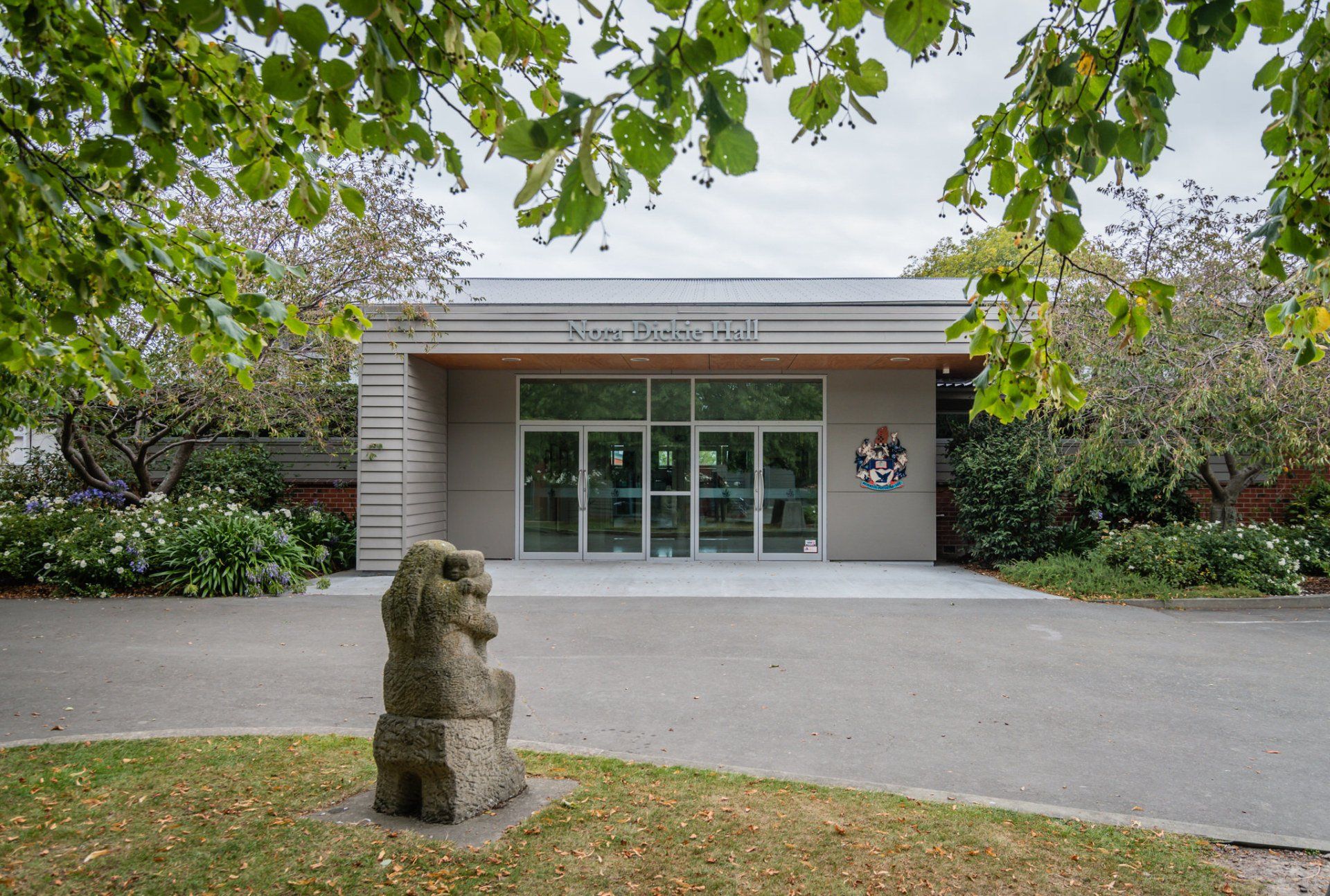 A large building with a statue in front of it.