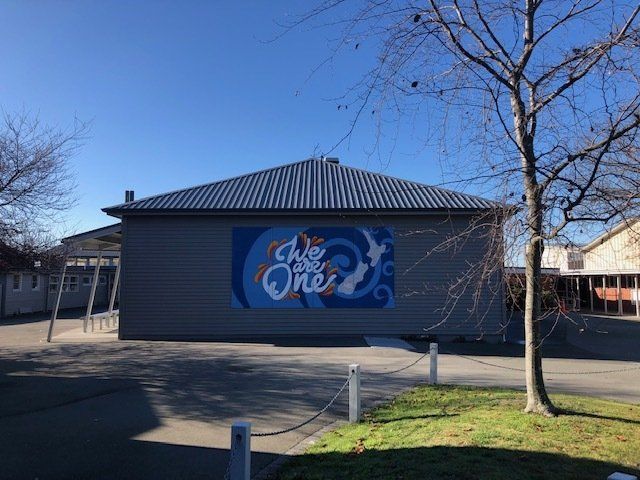 A building with a sign on the side that says we are one