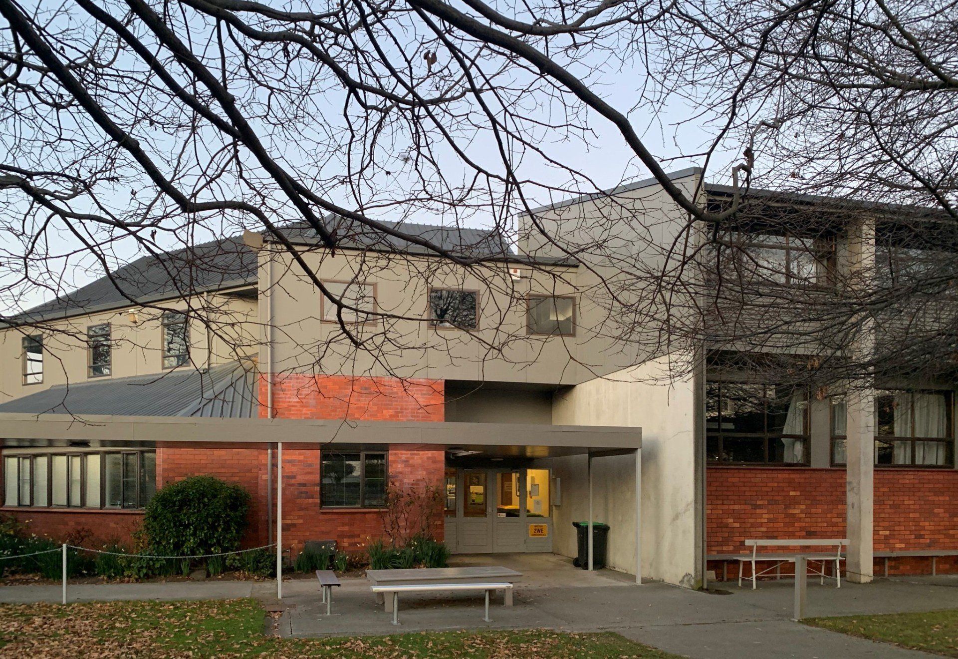 A brick building with a canopy over the entrance