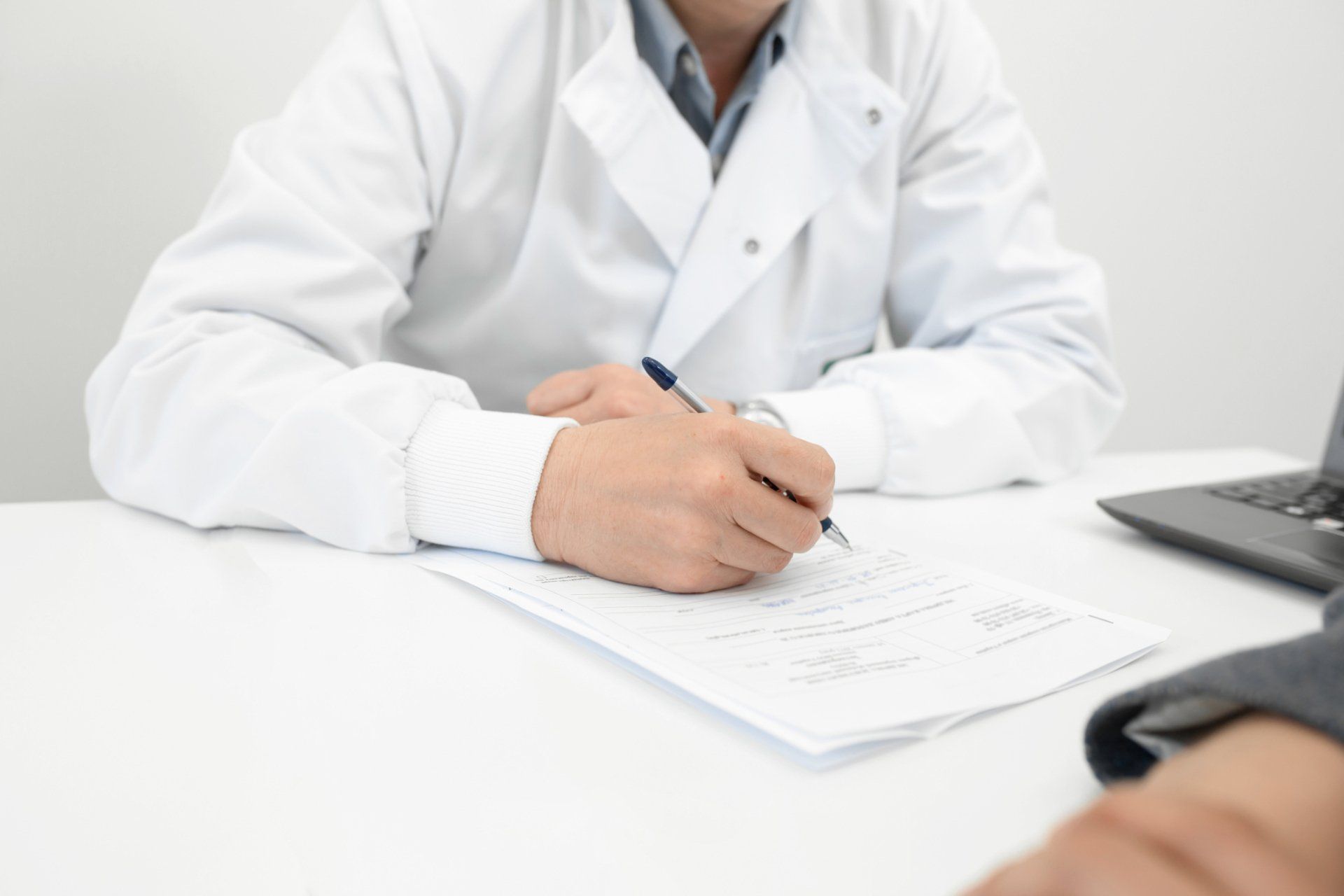 Doctor makes notes on patient medical record - Grand Rapids, MI - Urology Associates of Grand Rapids, PC