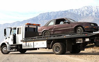 Tow truck carrying car - Emergency service towing in Oxnard, California Tow truck carrying car - Emergency service towing in Oxnard, California