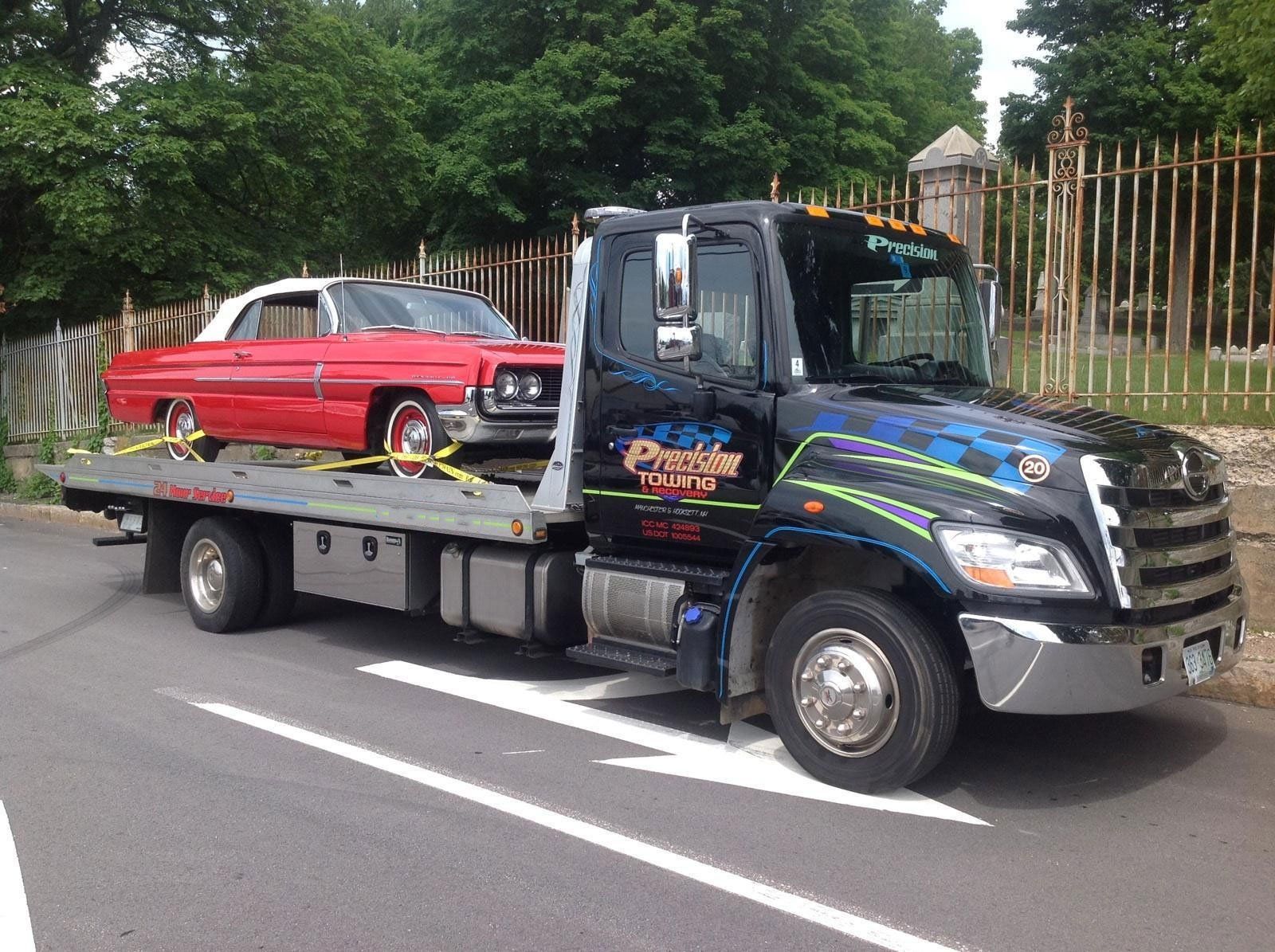 tow truck moving a classic car