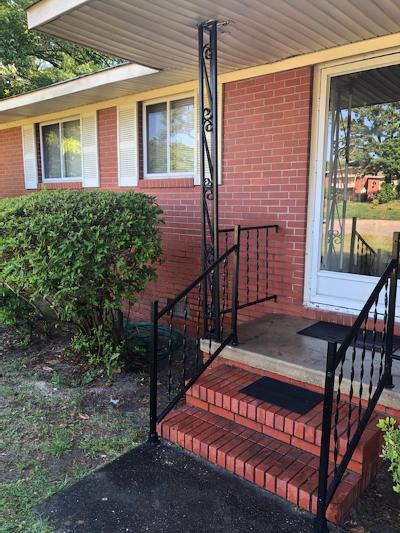 front porch with awning on brick house