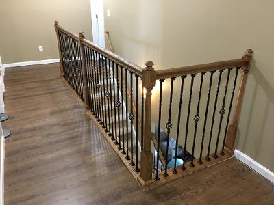 decorative wrought iron baluster on wooden railing