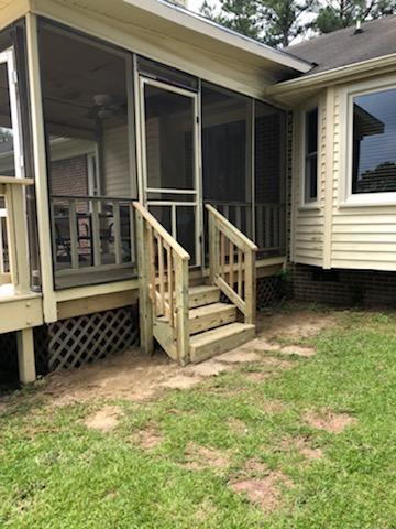 wooden stairs leading into screened porch
