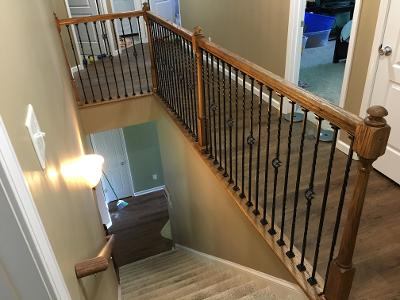 decorative wrought iron baluster added to wooden railing