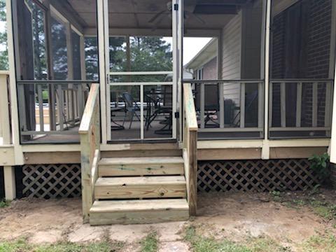 wooden stairs leading into screened porch