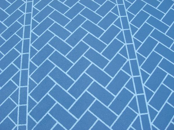 blue bricks layed in herringbone pattern