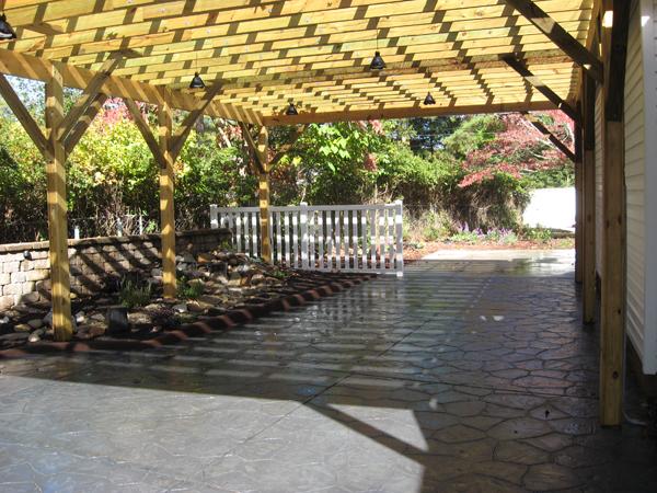 stone pattern pation with pergola and rock garden