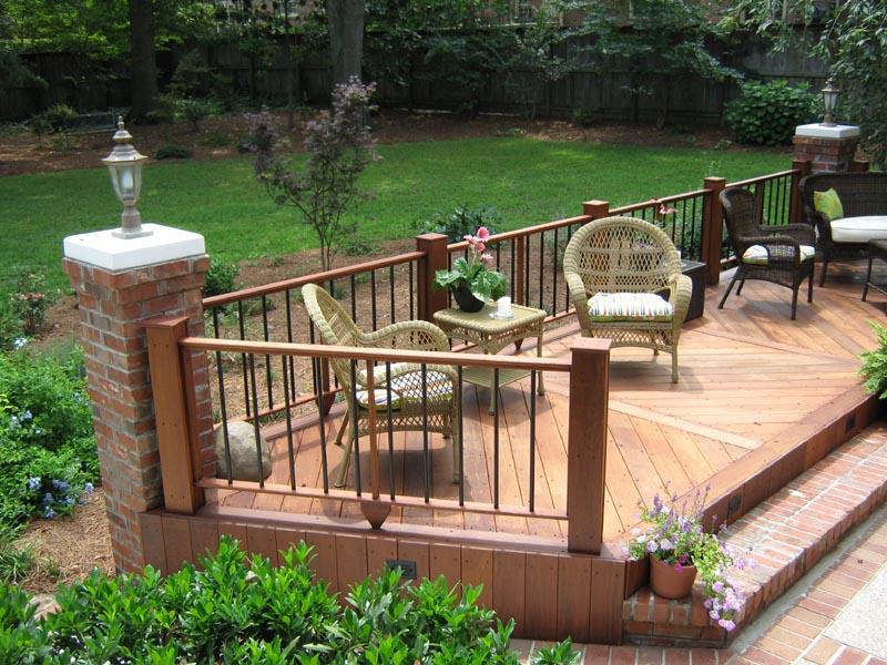 corner of wooden deck attached to brick column with sunken patio