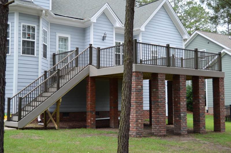 new gray deck with brick footers