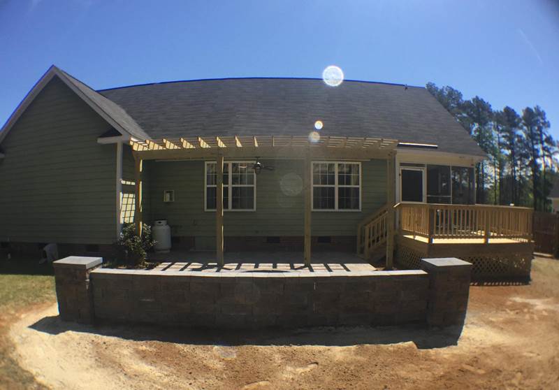 back patio with pergola and seating wall