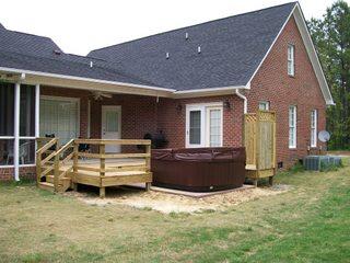 small deck on back of house with jacuzzi