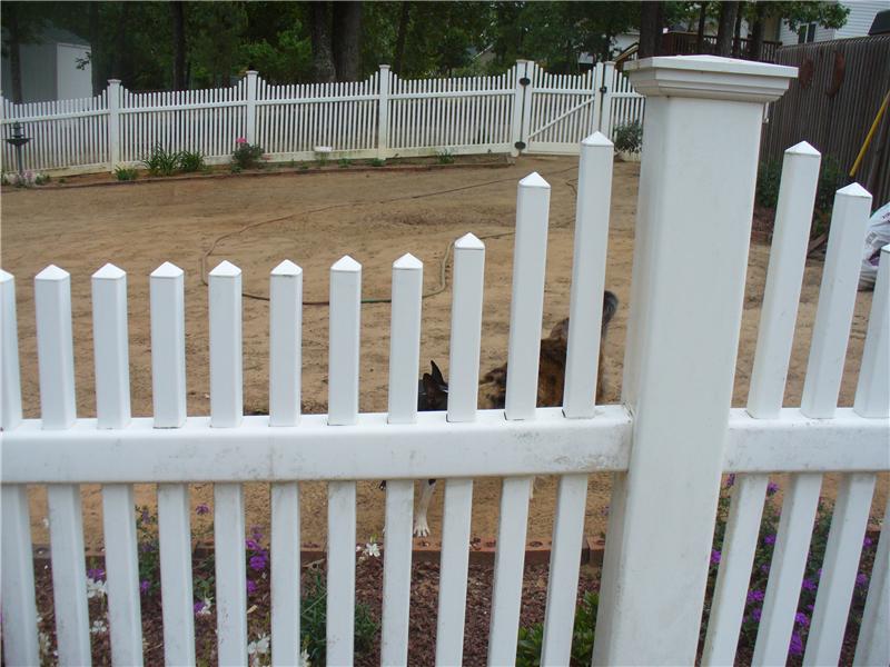 close up of white vinyl picket fence