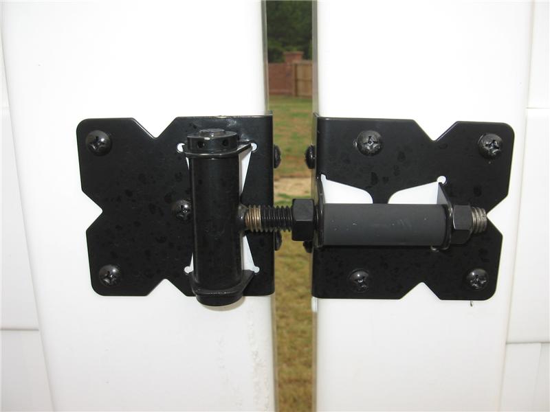gate hinge on white vinyl fence
