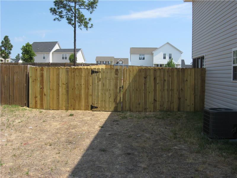side view of board on board fence with gate