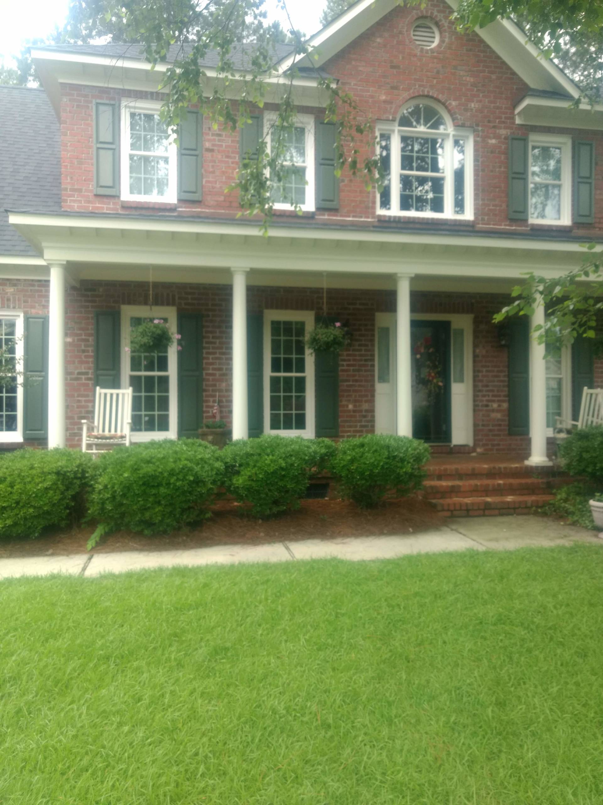 several windows on front of brick house