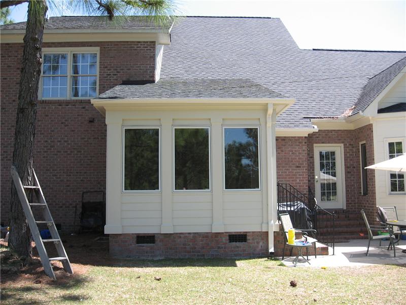 back view of sunroom addtion on brick house