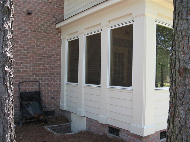side view of sunroom addtion on brick house