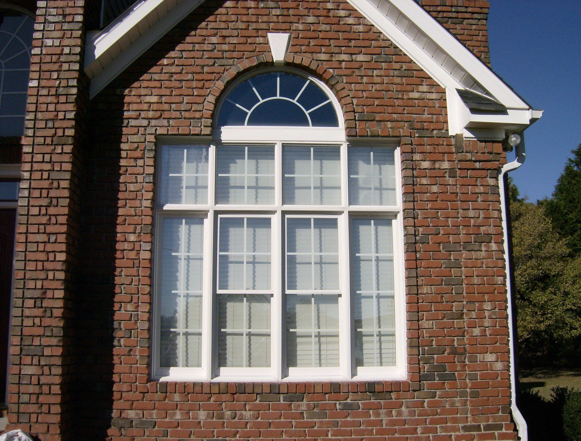 decorative front window replacement on brick house