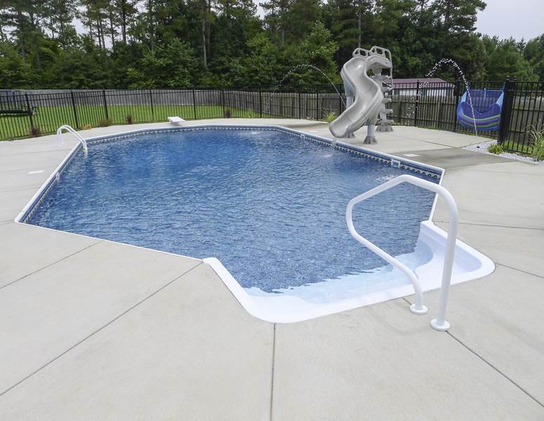 stairs and railing leading into pool with slide