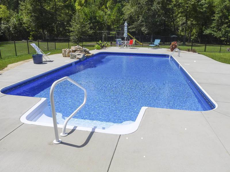 stairs leading into pool with rock formation waterfall