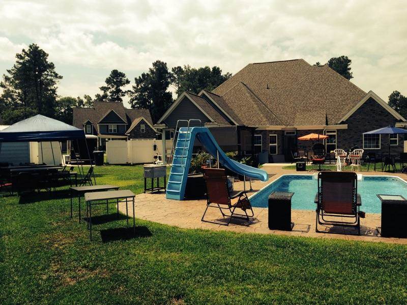 back yard with pool chairs and patio set