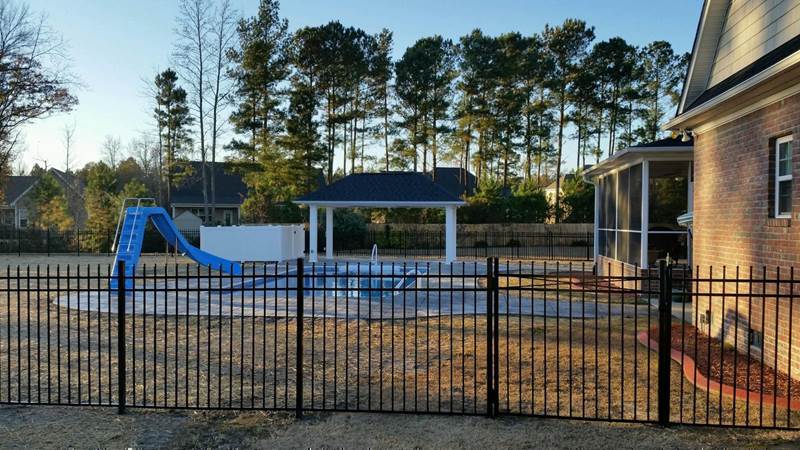 wrought iron fence with pool in background