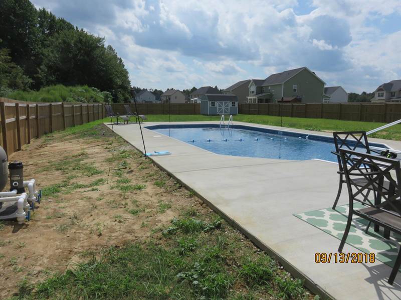 pool with wooden fence surrounding