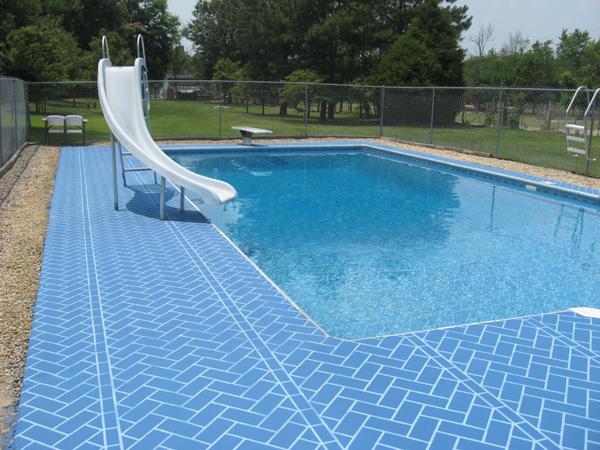 inground pool with slide and blue brick surround