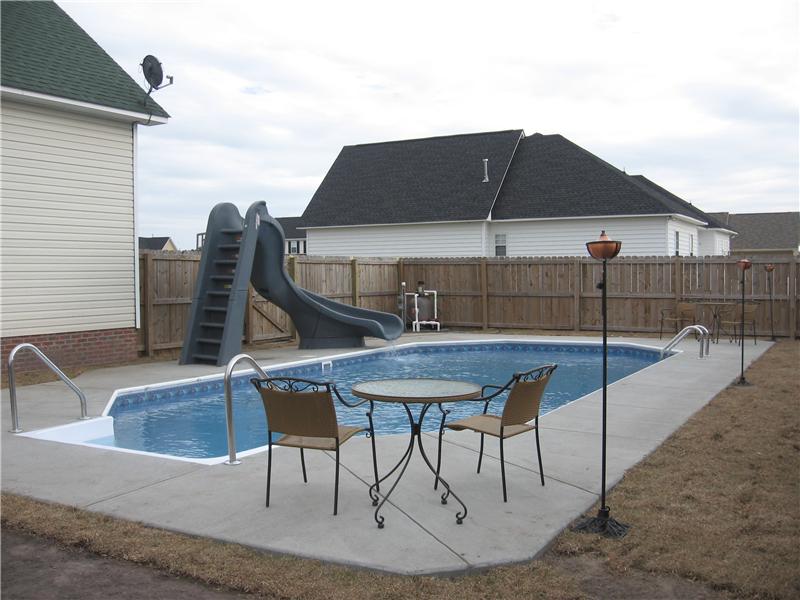 inground pool with sliding board
