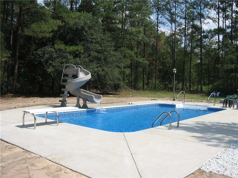 inground pool with twisting slide
