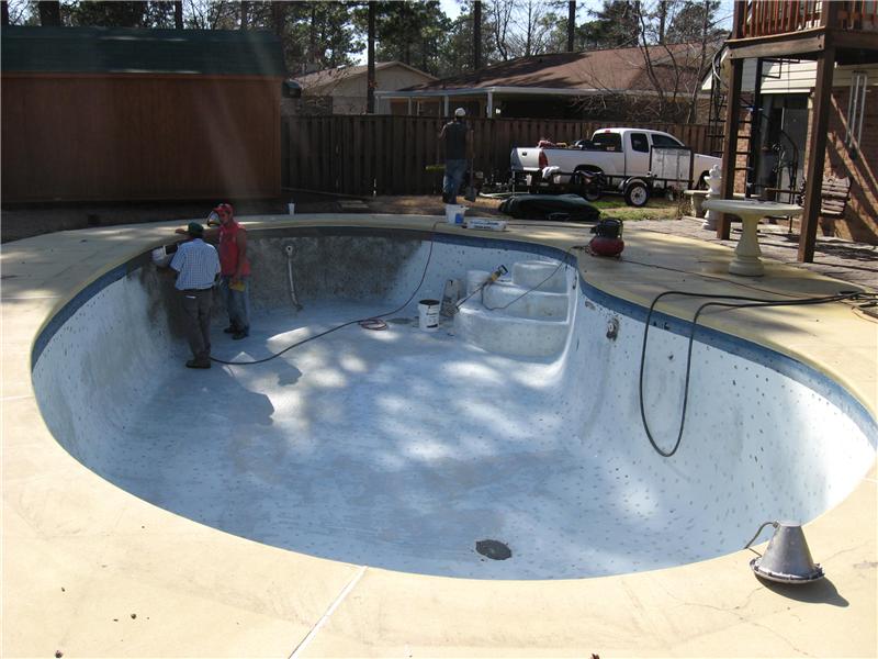 2 maile contractors standing in unfinished concrete pool