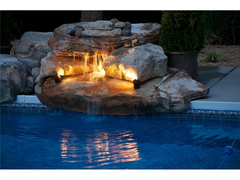 inground pool with waterfall
