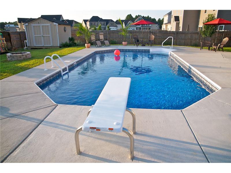 diving  board and pink ball floating in pool