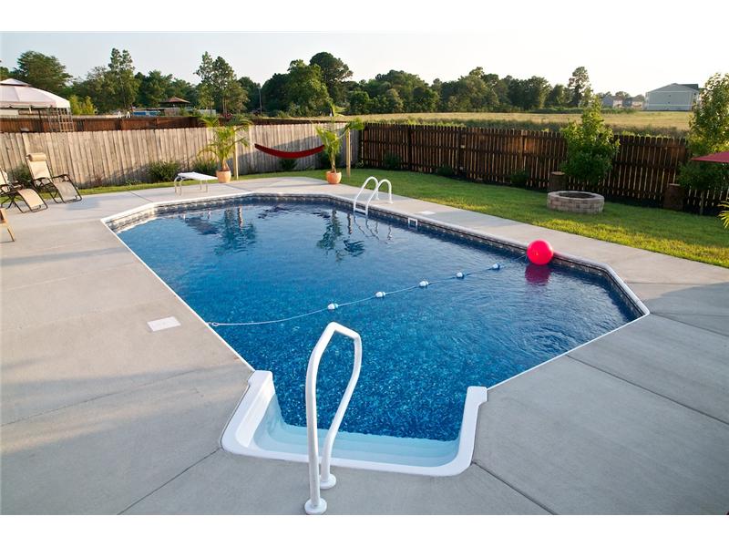 stairs leading into pool with pink ball floating