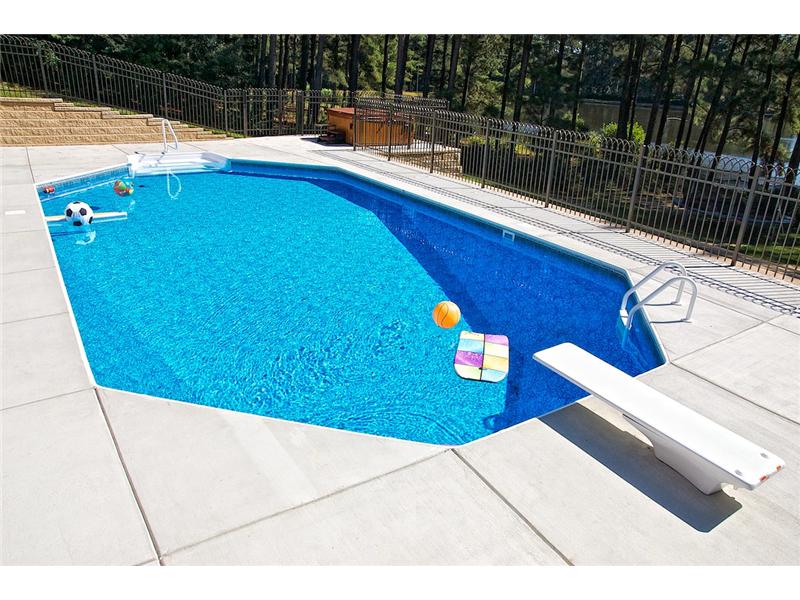 pool with diving board and floating toys