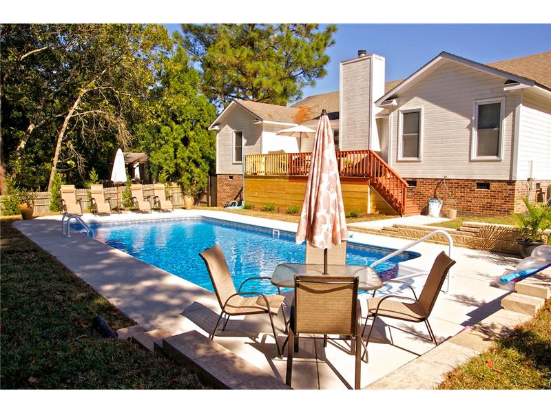 patio set on decking with pool in background