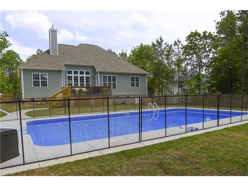 fence surrounding pool and back of house