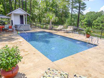 rectangular pool with hot tub in background