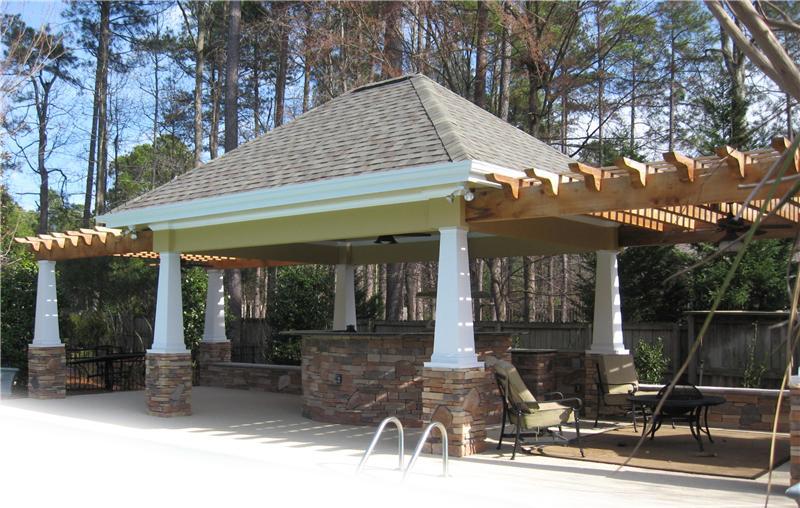 covered outdoor kitchen with 2 pergola structures attached on each side