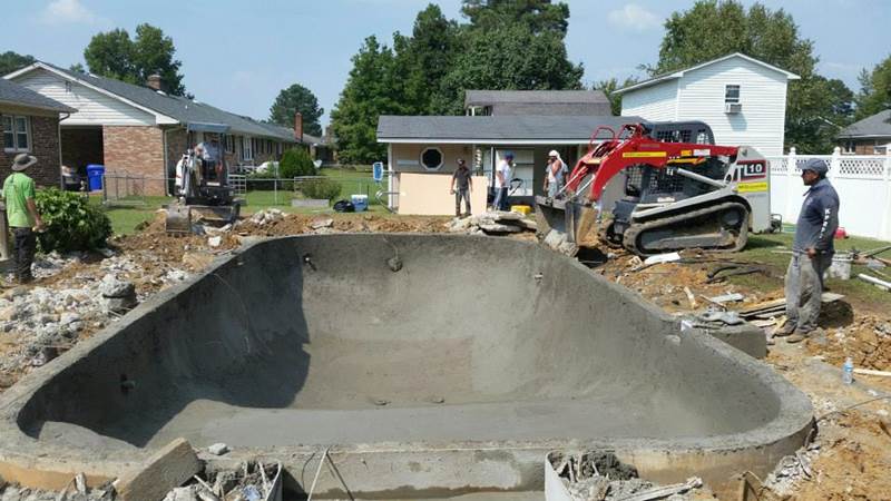 back hoes working on construction of inground pool