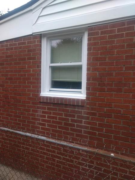 small single window on side of brick house