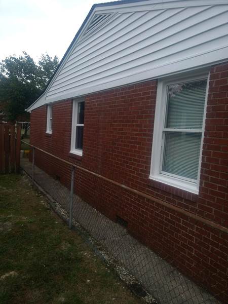 3 small single windows on side of brick house