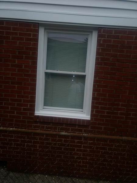 small single window on side of brick house
