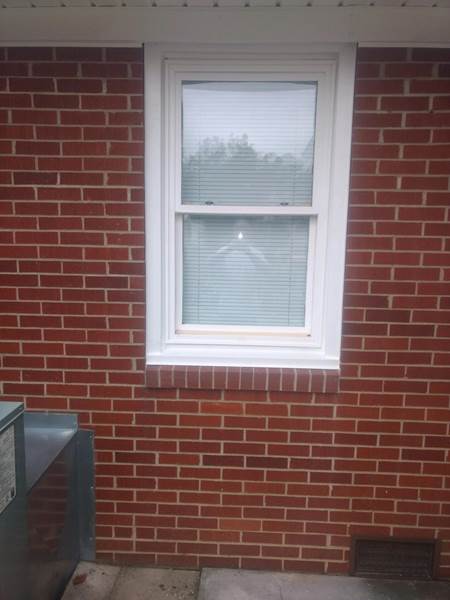 small single window on side of brick house